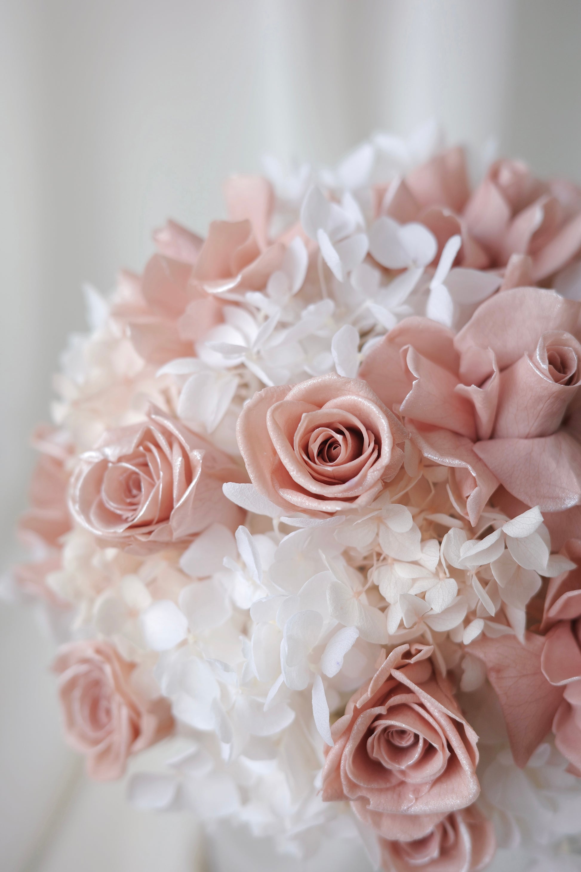 Blush pink preserved roses and white hydrangeas in a luxury floral box gift arrangement