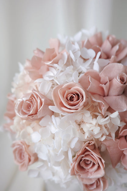 Blush pink preserved roses and white hydrangeas in a luxury floral box gift arrangement