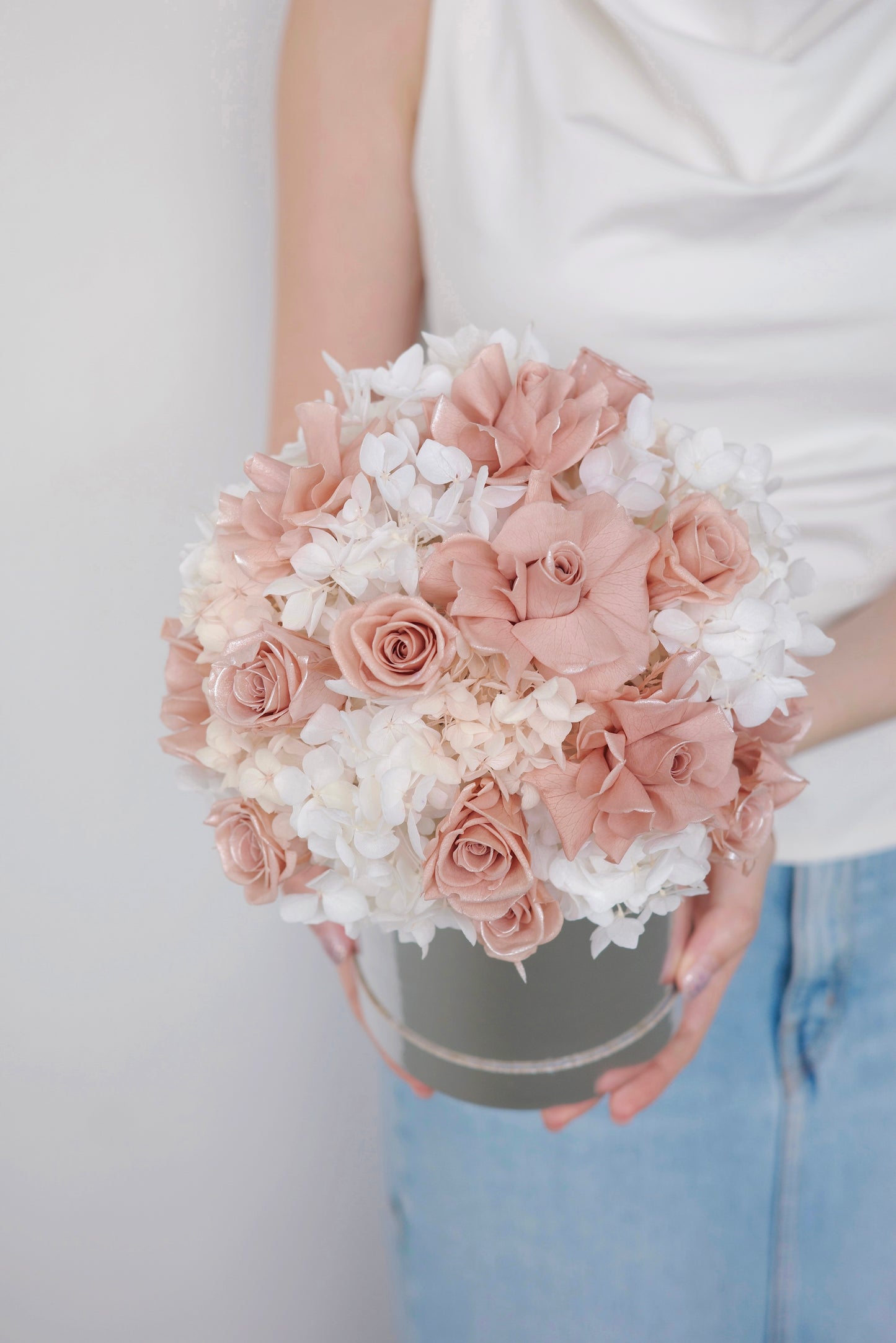 Blush pink preserved roses and white hydrangeas in a luxury floral box gift arrangement