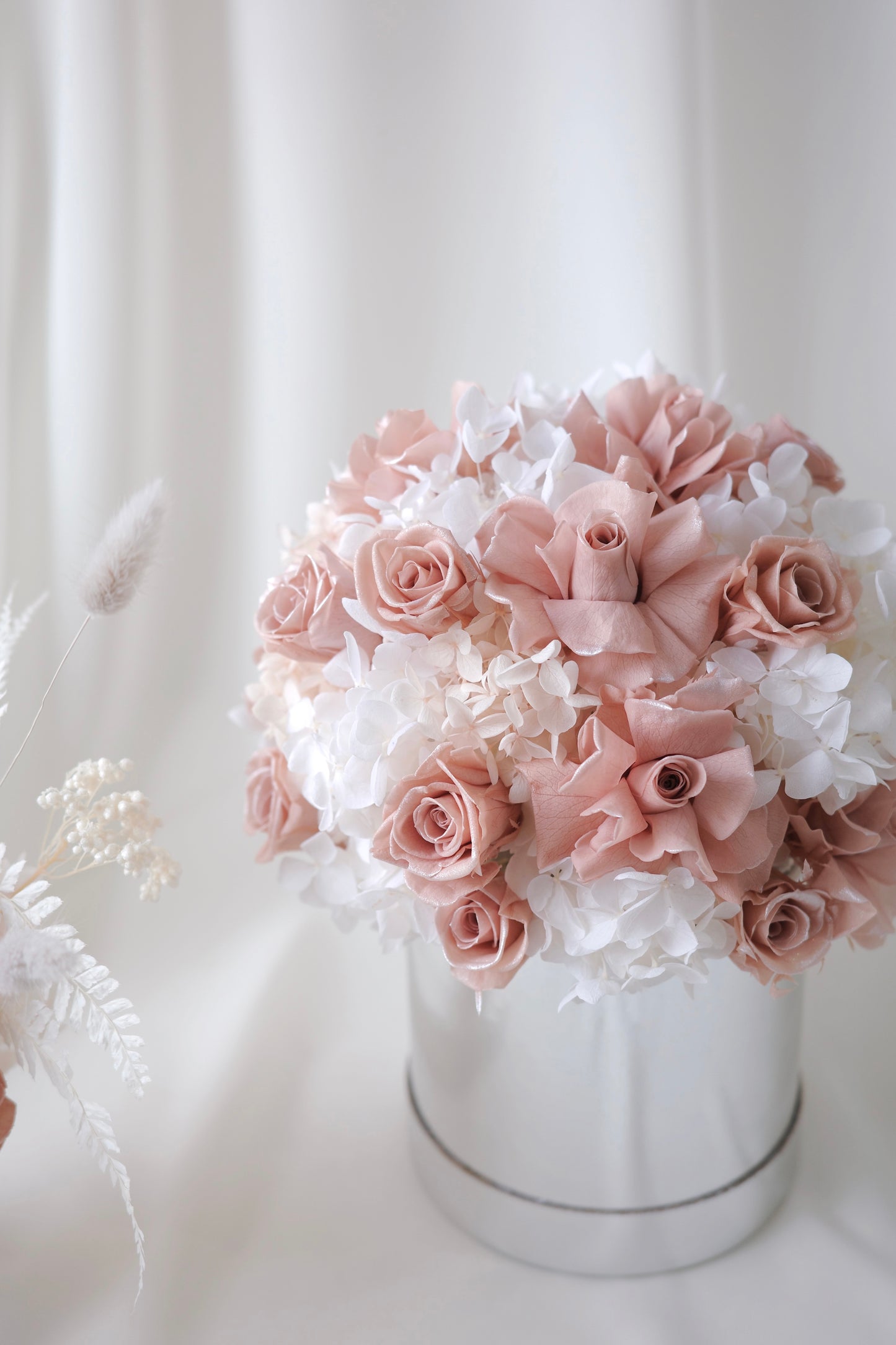 Blush pink preserved roses and white hydrangeas in a luxury floral box gift arrangement