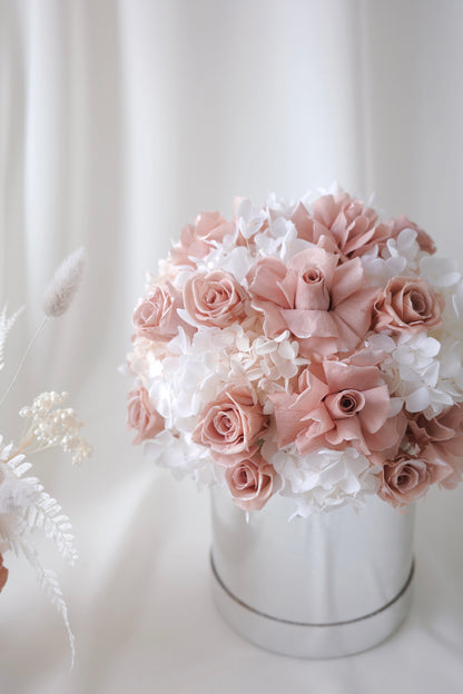 Blush pink preserved roses and white hydrangeas in a luxury floral box gift arrangement