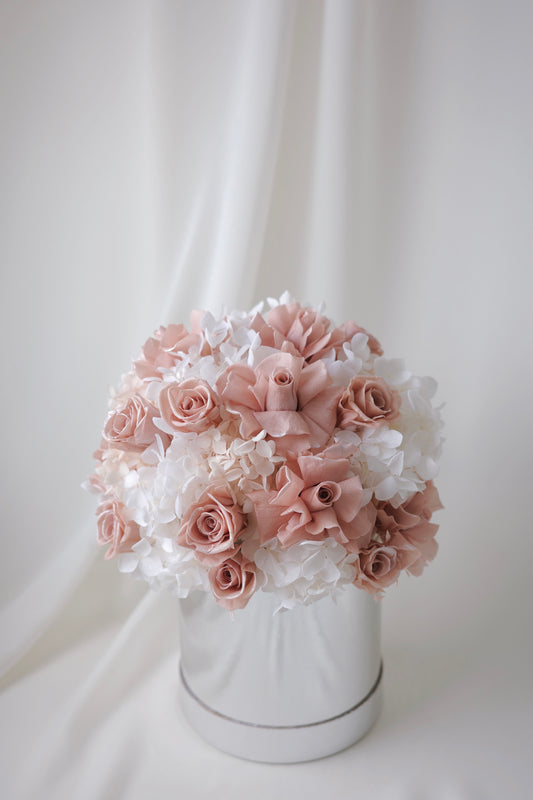 Blush pink preserved roses and white hydrangeas in a luxury floral box gift arrangement