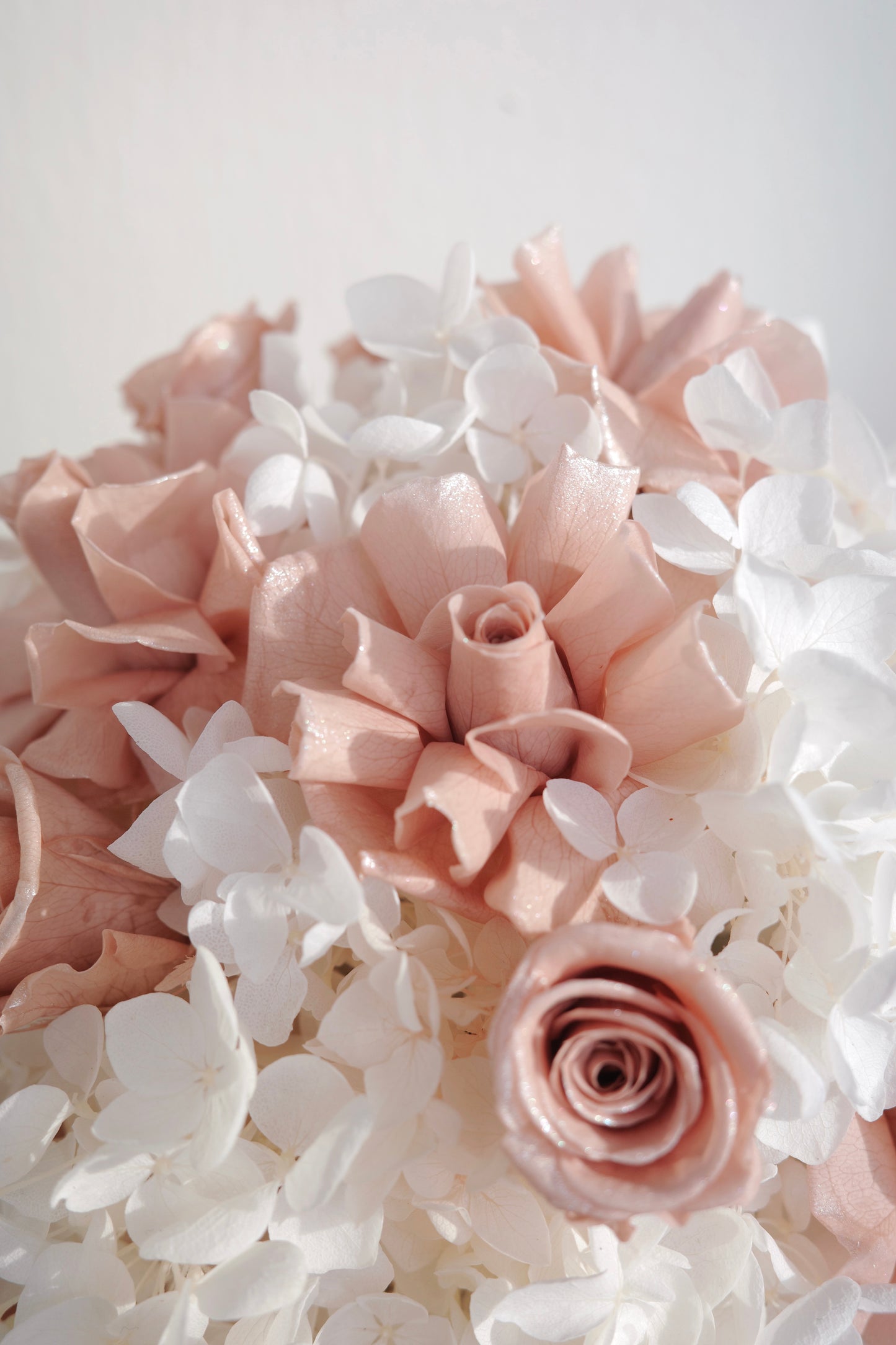Blush pink preserved roses and white hydrangeas in a luxury floral box gift arrangement