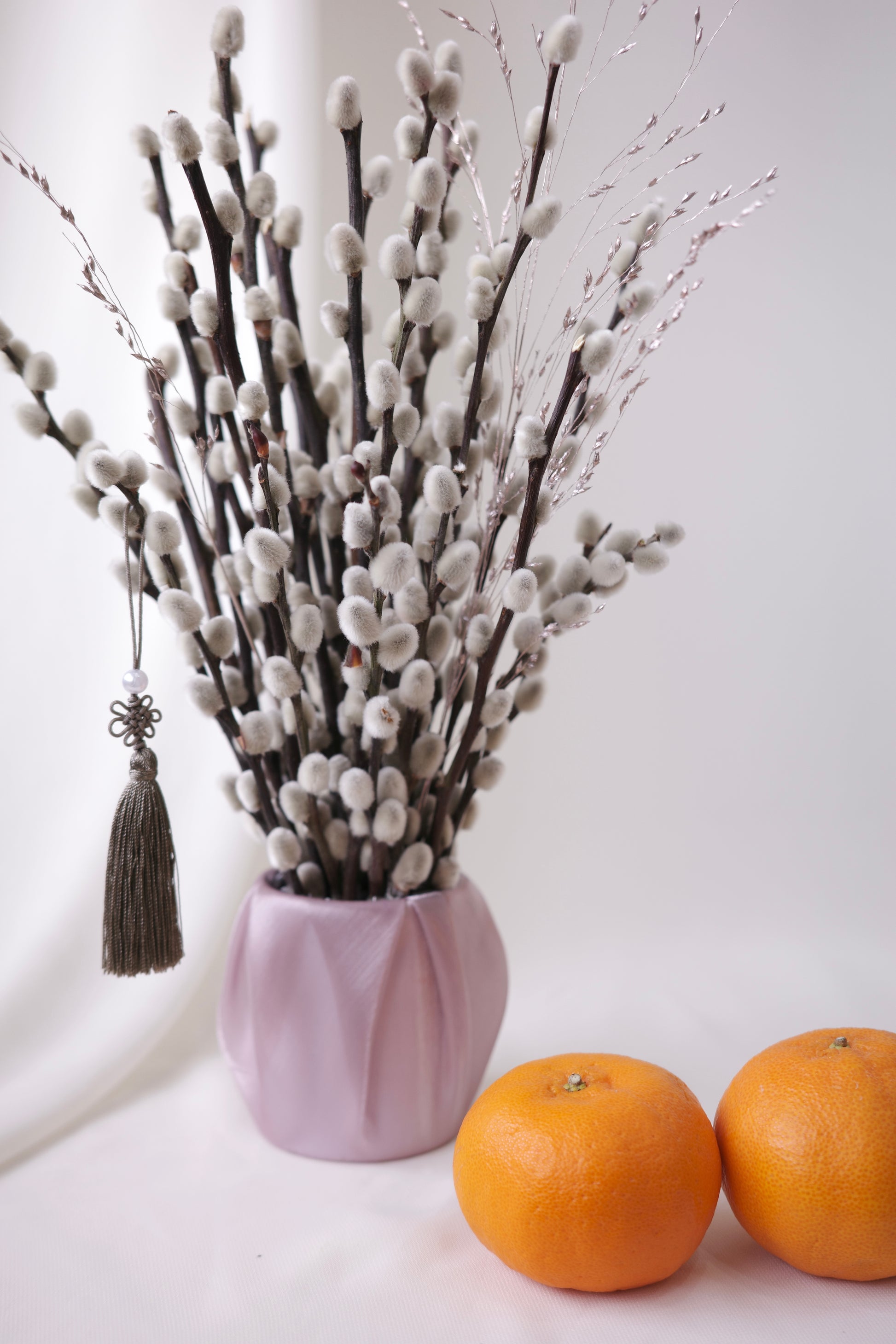 Petite silver pussy willow branches in a blush pot, with tassel