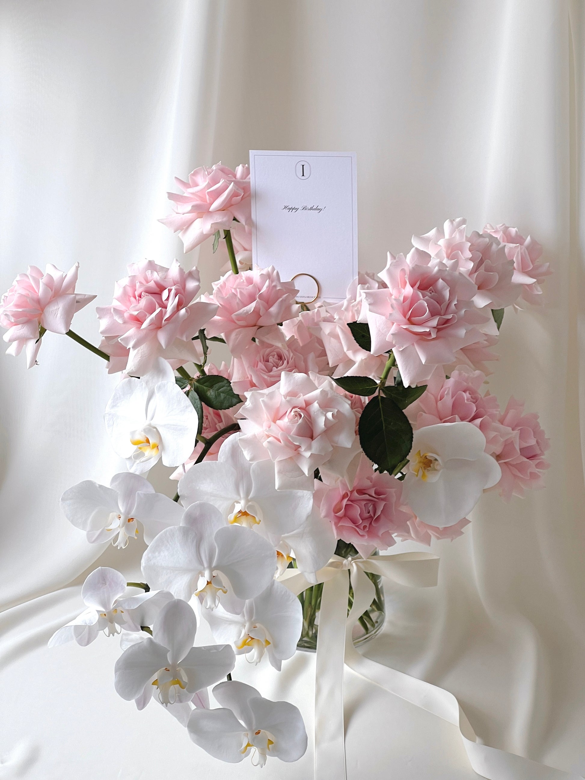 Rose Renaissance vase arrangement with blush pink roses and cascading white orchids.