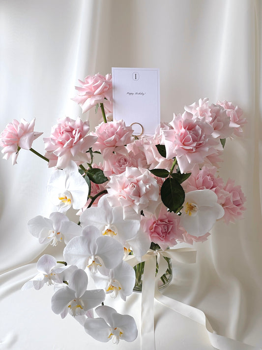 Rose Renaissance vase arrangement with blush pink roses and cascading white orchids.