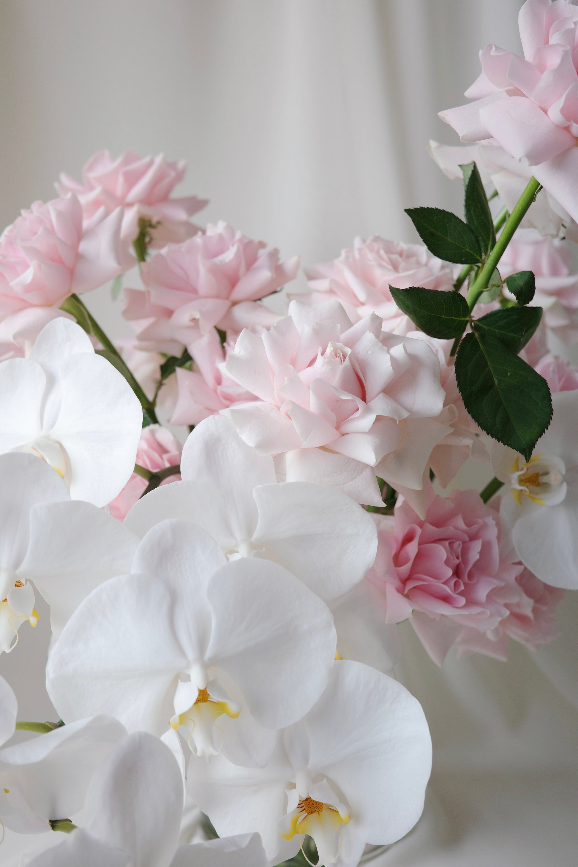 Luxury pink rose and orchid floral arrangement in a glass vase, perfect for birthdays and anniversaries.