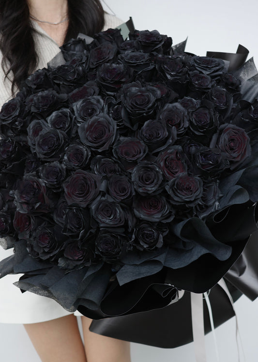 Luxurious bouquet of 99 black roses, hand-arranged to symbolize eternal love and devotion,  the perfect statement of romance and passion.