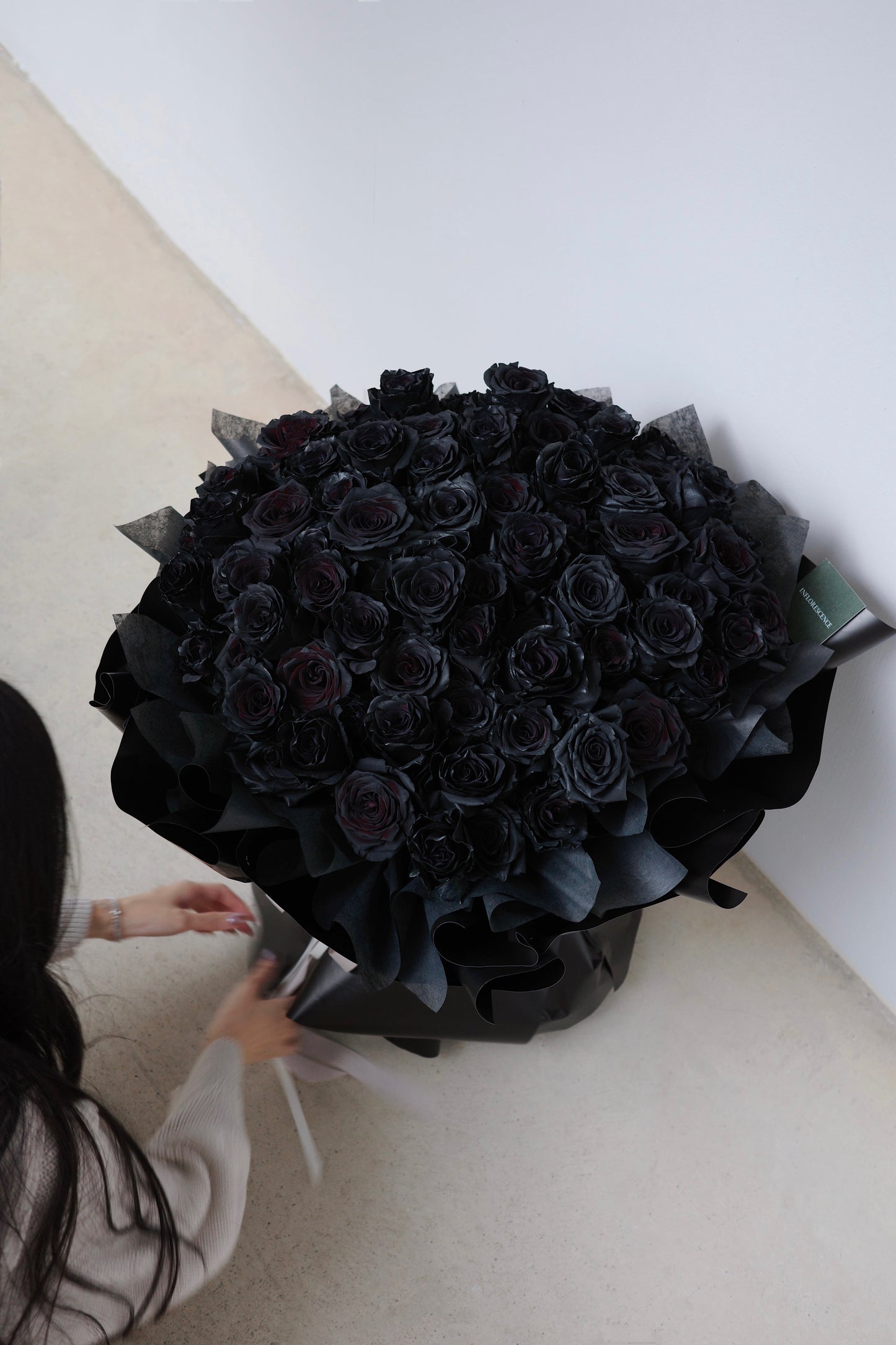 Luxurious bouquet of 99 black roses, hand-arranged to symbolize eternal love and devotion,  the perfect statement of romance and passion.