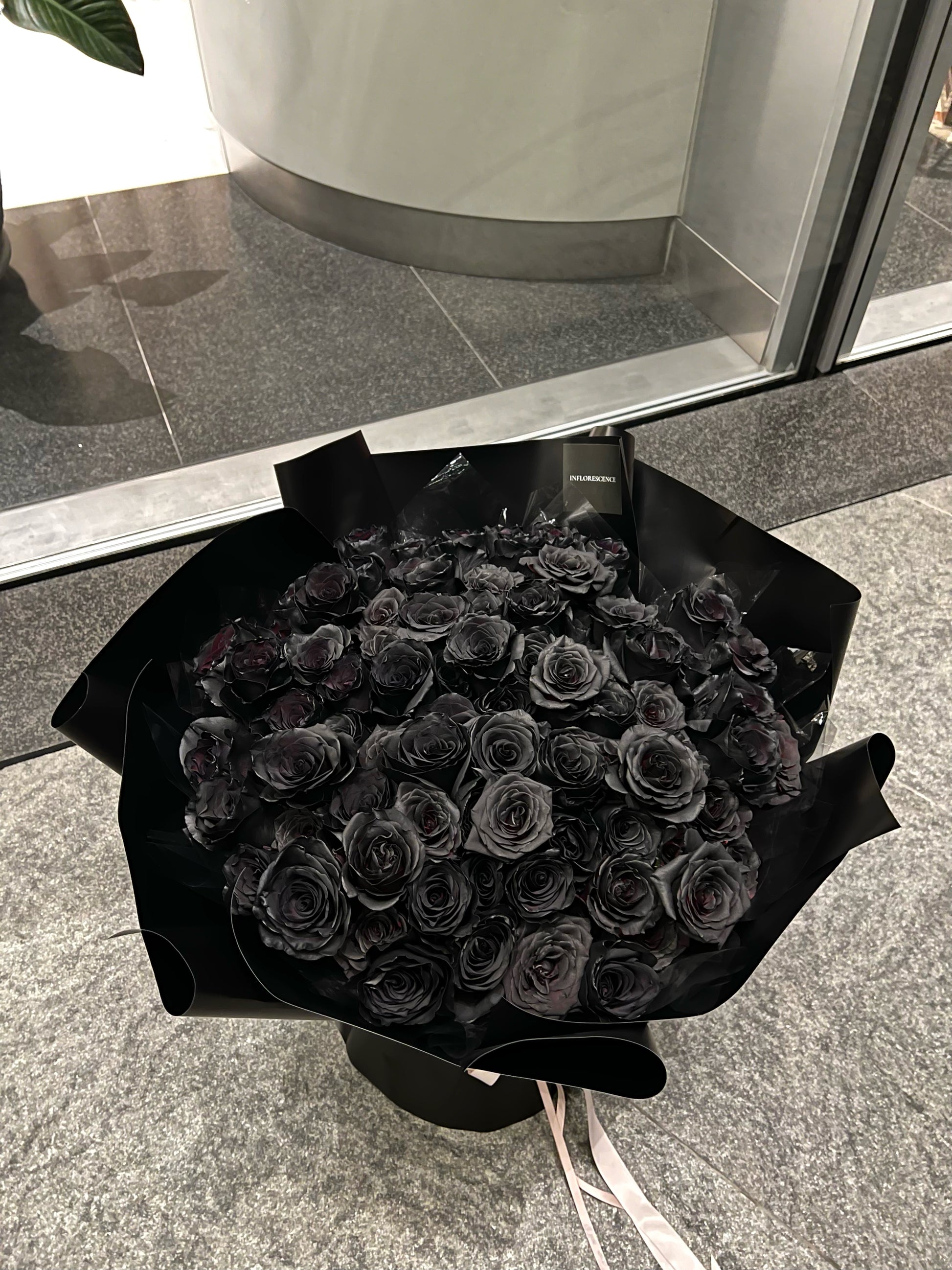 Luxurious bouquet of 99 black roses, hand-arranged to symbolize eternal love and devotion,  the perfect statement of romance and passion.