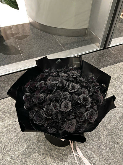 Luxurious bouquet of 99 black roses, hand-arranged to symbolize eternal love and devotion,  the perfect statement of romance and passion.