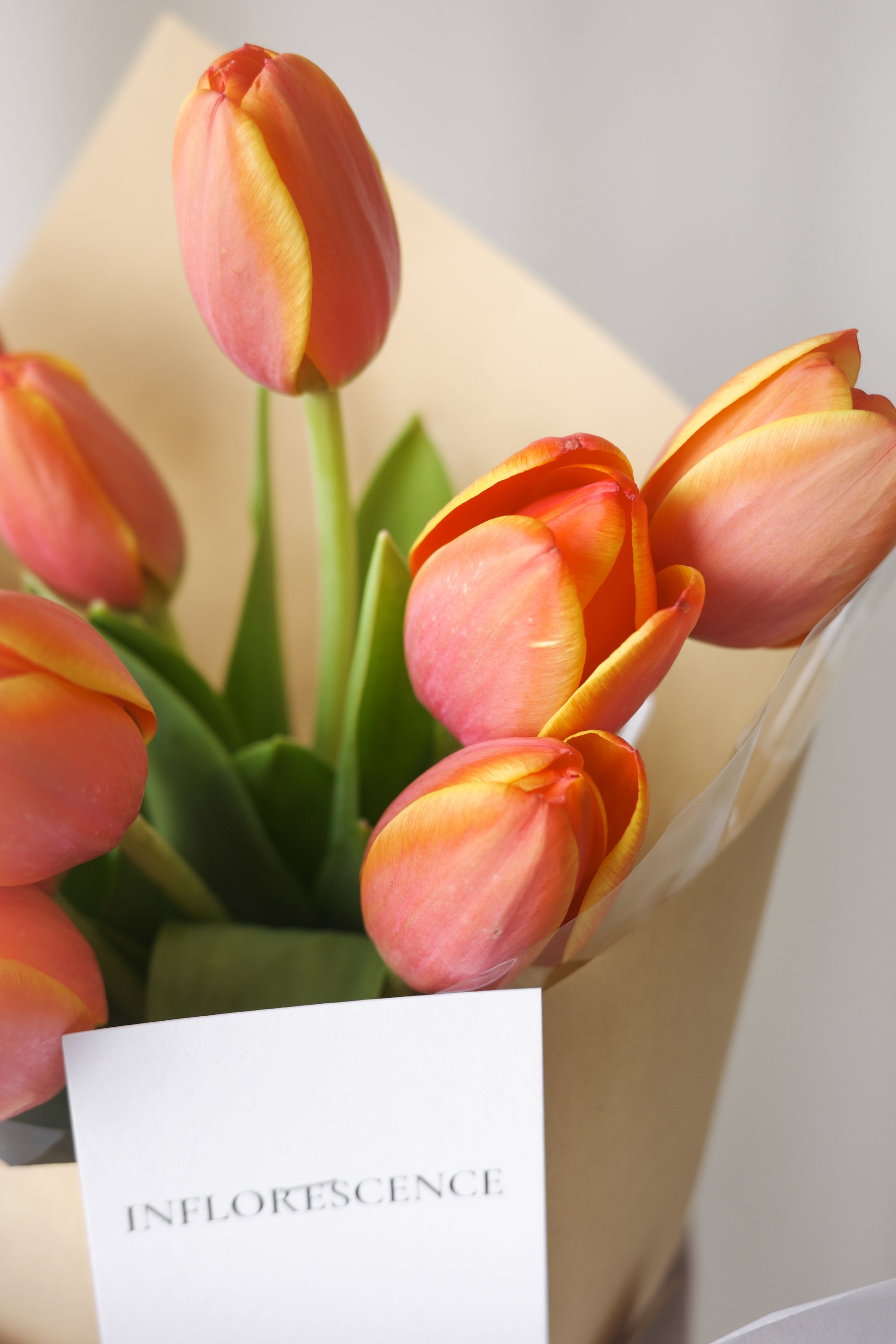 Hand-tied bouquet of fresh orange tulips for gifting or home decor