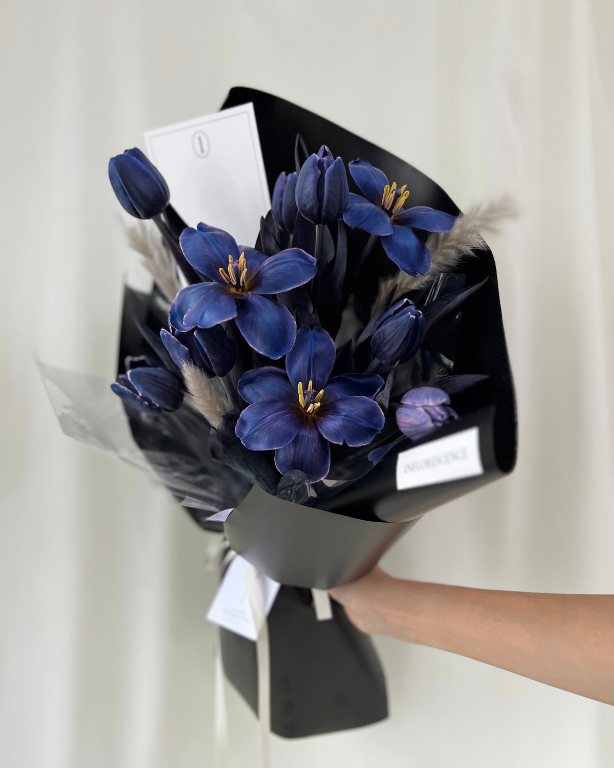 Deep blue tulip bouquet in a sculptural wrapped arrangement by Studio Inflorescence Singapore