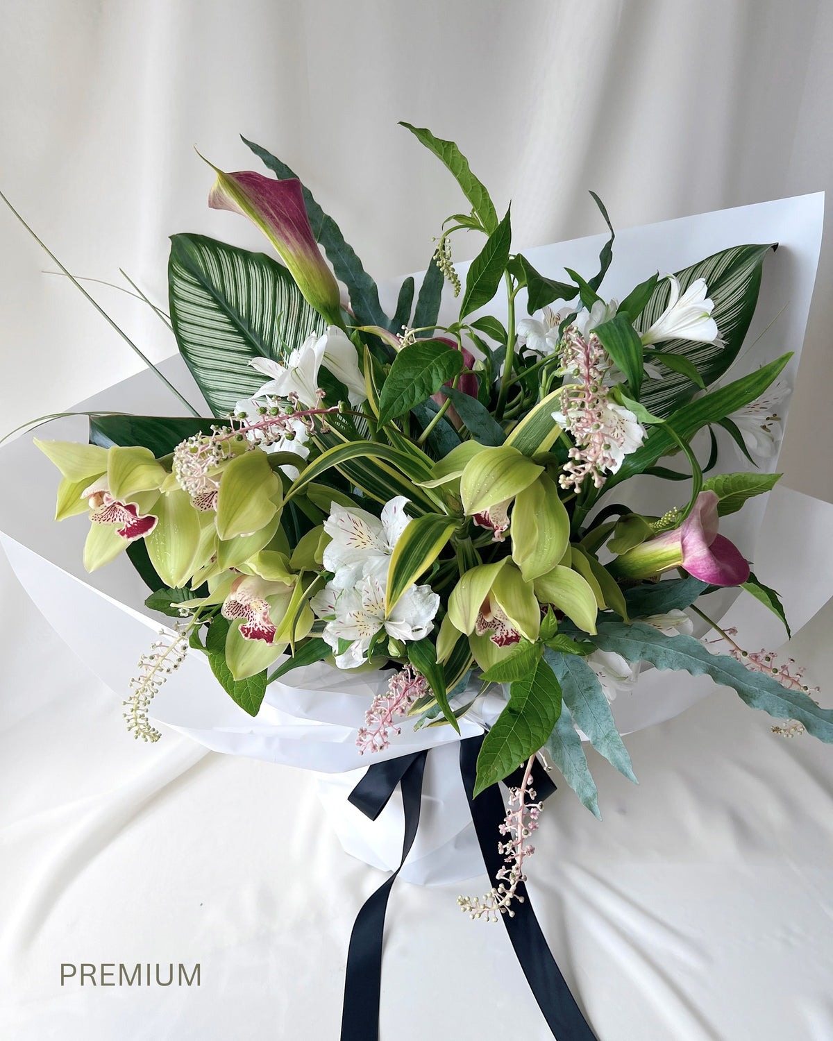Green botanical bouquet with lush foliage, sculptural branches, and fresh seasonal flowers by Studio Inflorescence Singapore