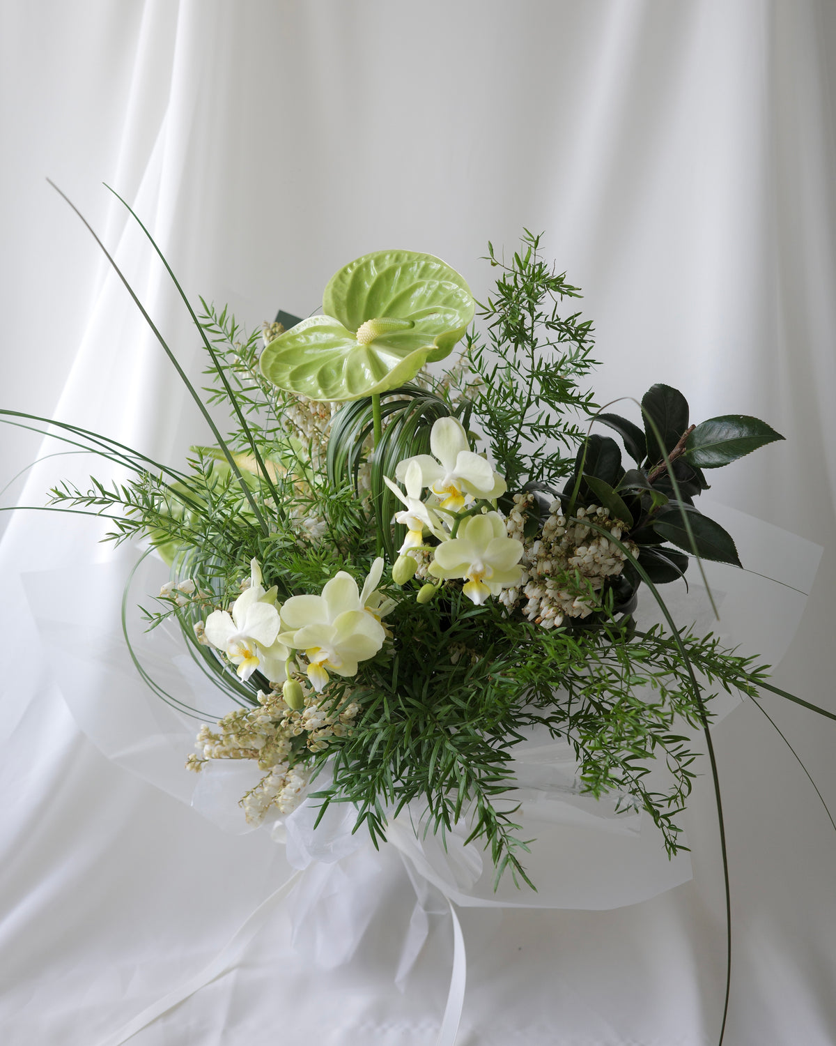 Green botanical bouquet with lush foliage, sculptural branches, and fresh seasonal flowers by Studio Inflorescence Singapore