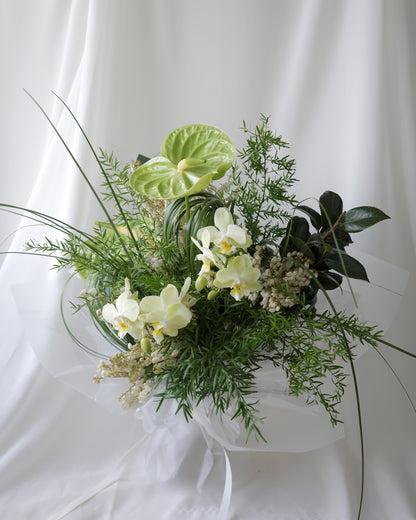 Green botanical bouquet with lush foliage, sculptural branches, and fresh seasonal flowers by Studio Inflorescence Singapore