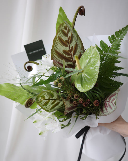 Green botanical bouquet with lush foliage, sculptural branches, and fresh seasonal flowers by Studio Inflorescence Singapore