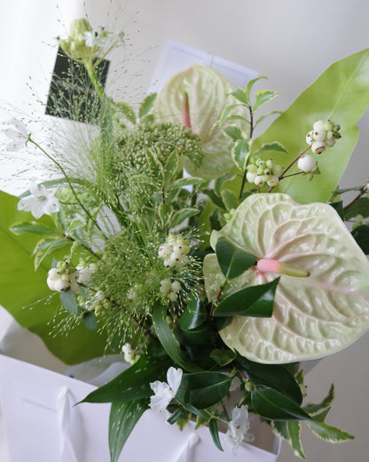 Green botanical bouquet with lush foliage, sculptural branches, and fresh seasonal flowers by Studio Inflorescence Singapore