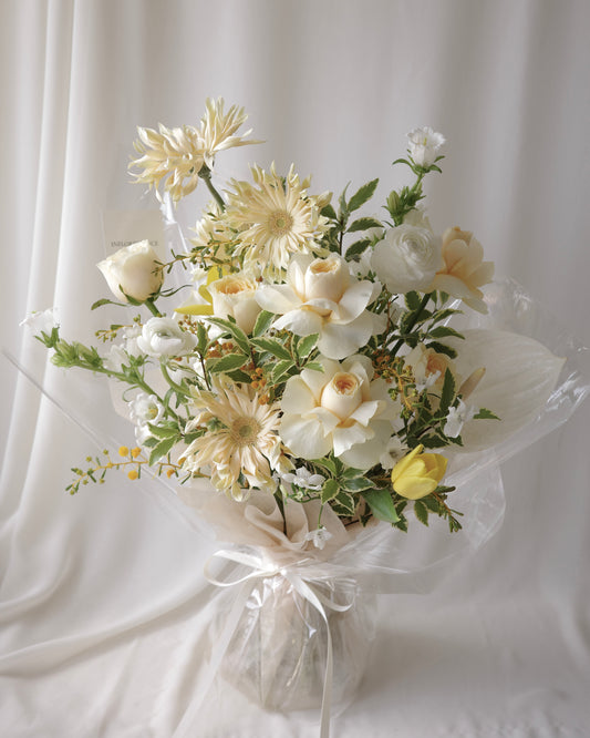 Premium yellow and white bouquet with tulips, roses, mimosa, and seasonal flowers by Studio Inflorescence Singapore