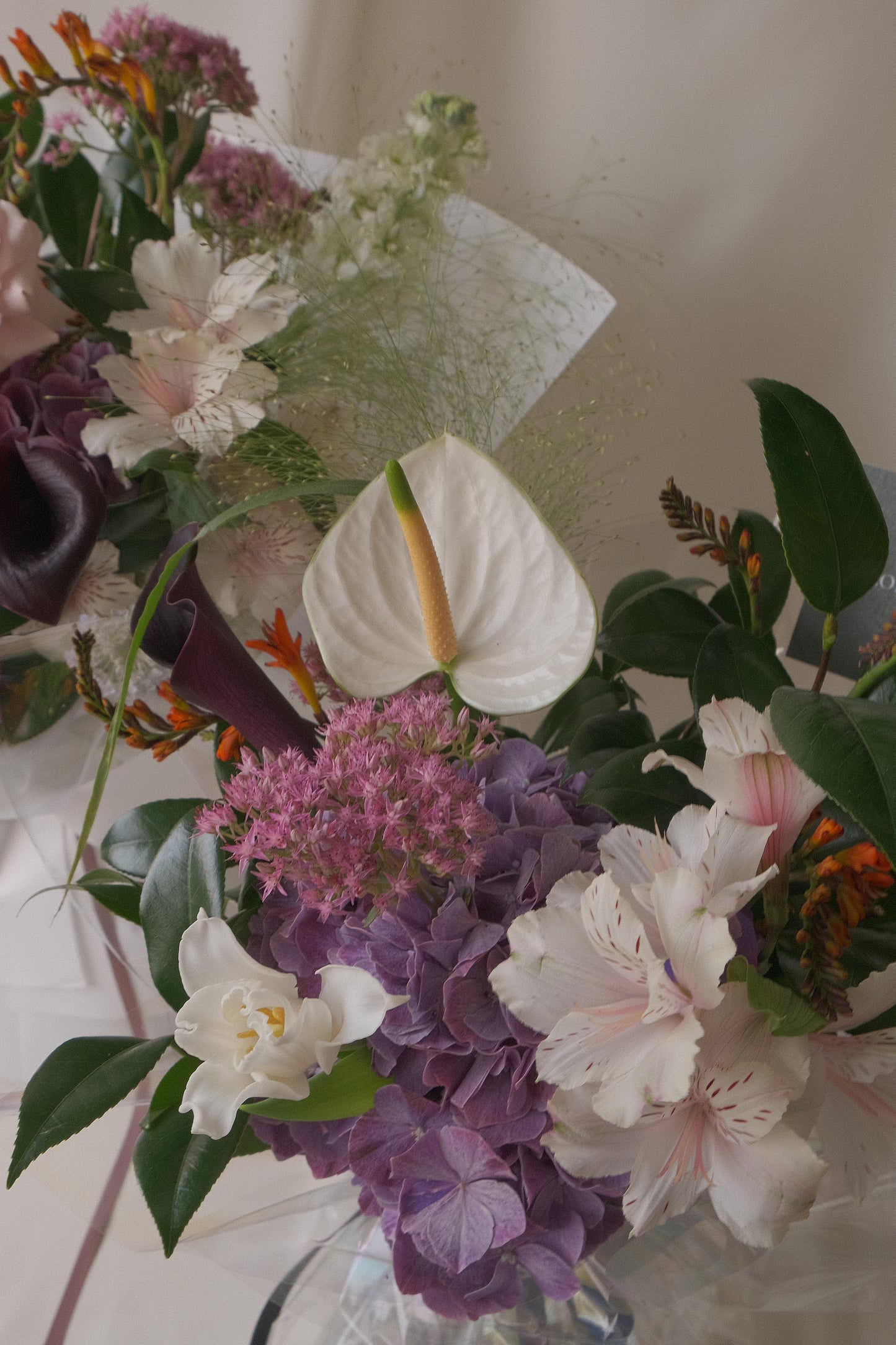 Close-up of layered seasonal flowers showing soft textures and tones in the Lover bouquet