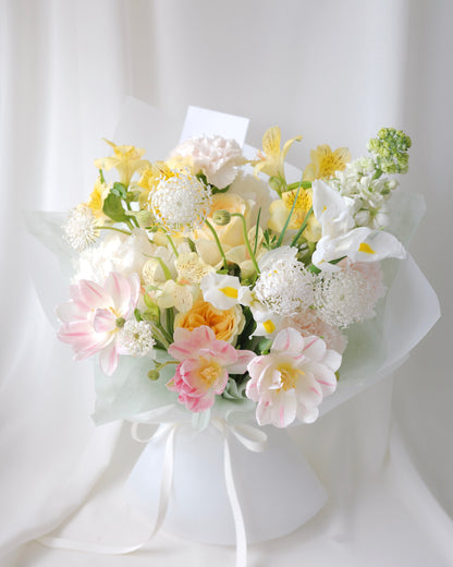 Seasonal bouquet in blush pink, butter yellow, white, and green by Studio Inflorescence Singapore