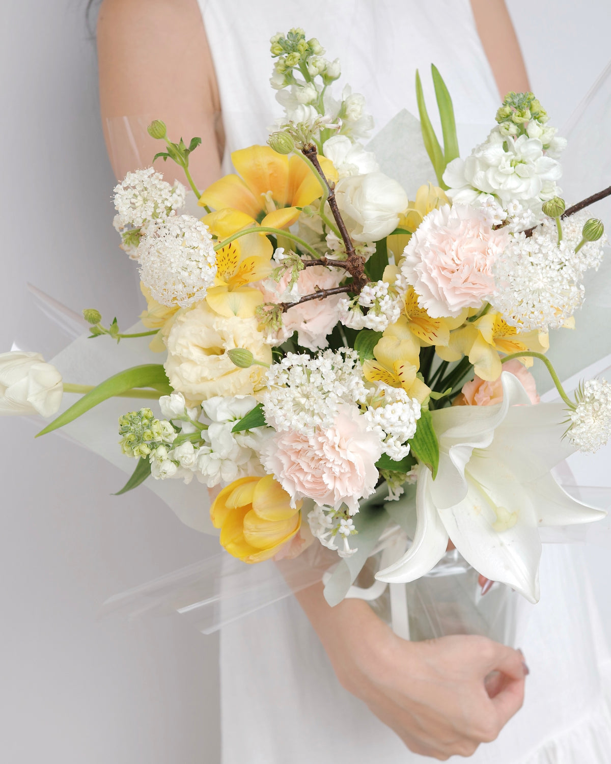 Seasonal bouquet in blush pink, butter yellow, white, and green by Studio Inflorescence Singapore