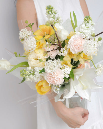 Seasonal bouquet in blush pink, butter yellow, white, and green by Studio Inflorescence Singapore