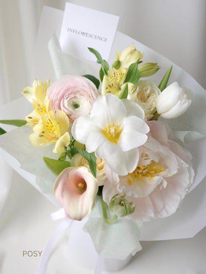 Seasonal bouquet in blush pink, butter yellow, white, and green by Studio Inflorescence Singapore