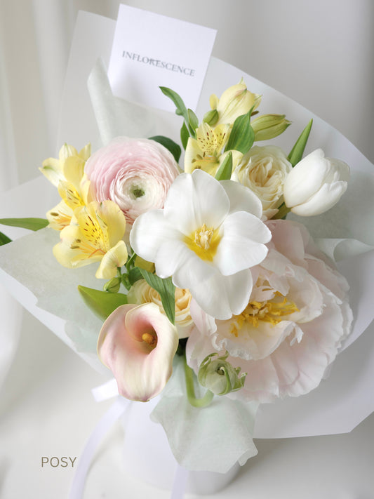 Seasonal bouquet in blush pink, butter yellow, white, and green by Studio Inflorescence Singapore